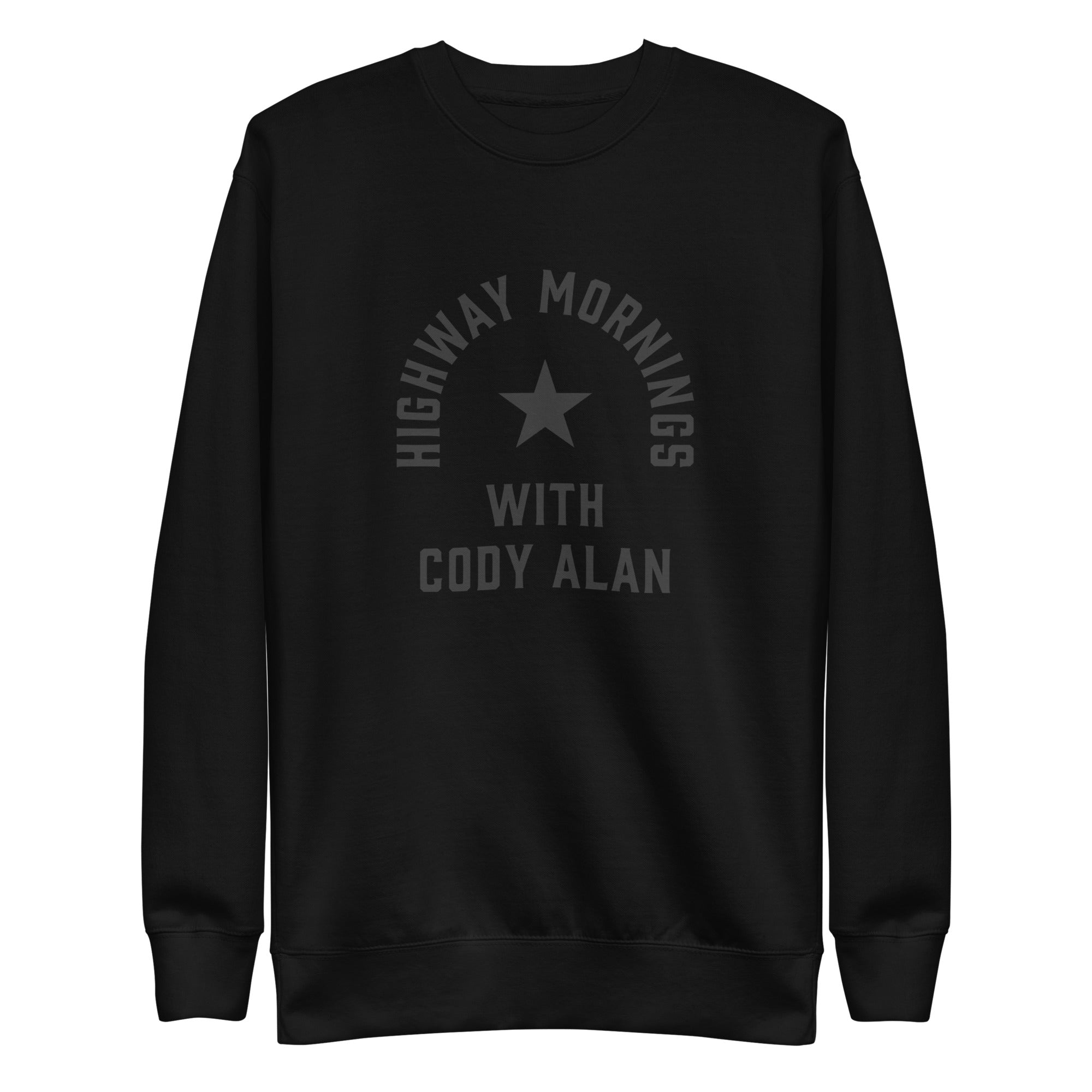 Flat lay front view of a black crewneck sweatshirt. The front features a black star and the text 'HIGHWAY MORNINGS WITH CODY ALAN' printed in black across the chest for a monochrome look.