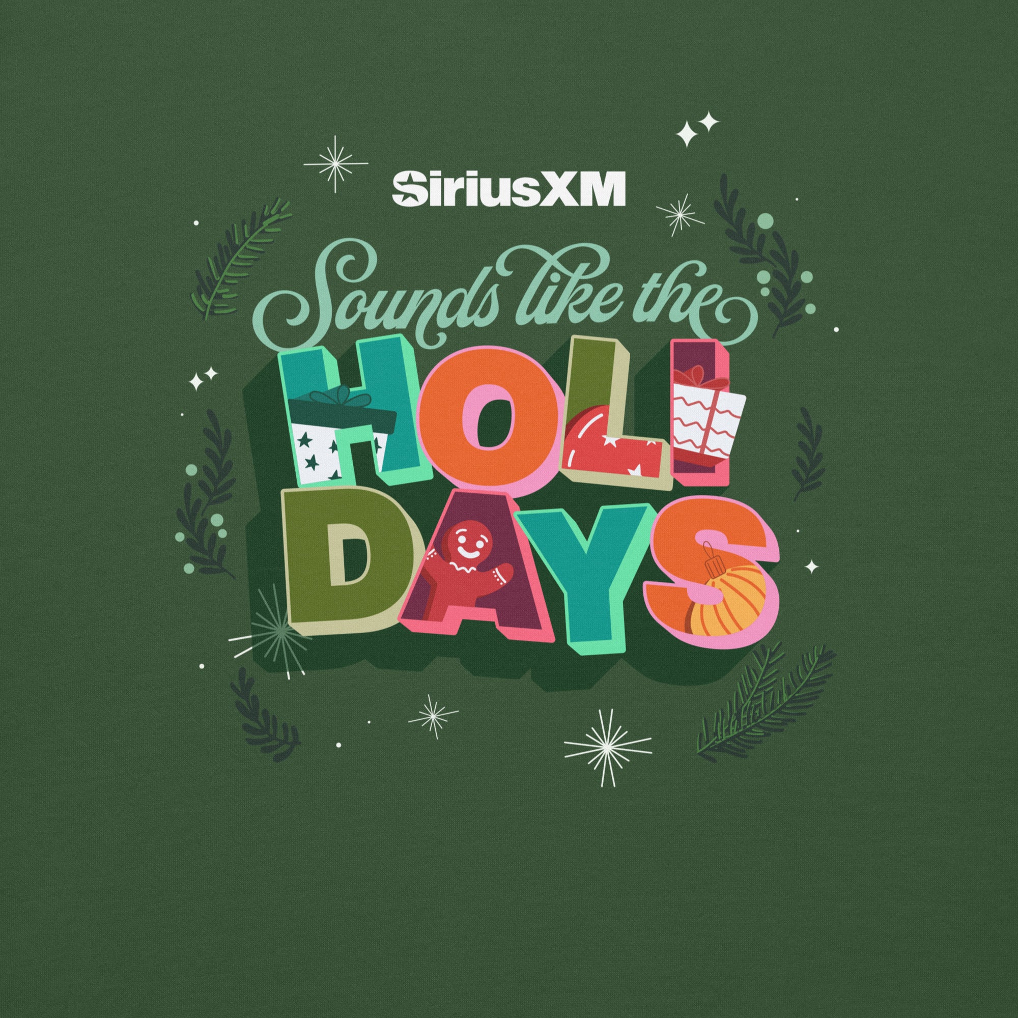 Close-up of the design on a forest green sweatshirt showing the white ‘SiriusXM’ logo and multicolored phrase ‘Sounds like the HOLIDAYS’ with illustrations of a present, gingerbread man, and ornament among snowflakes and evergreen sprigs.