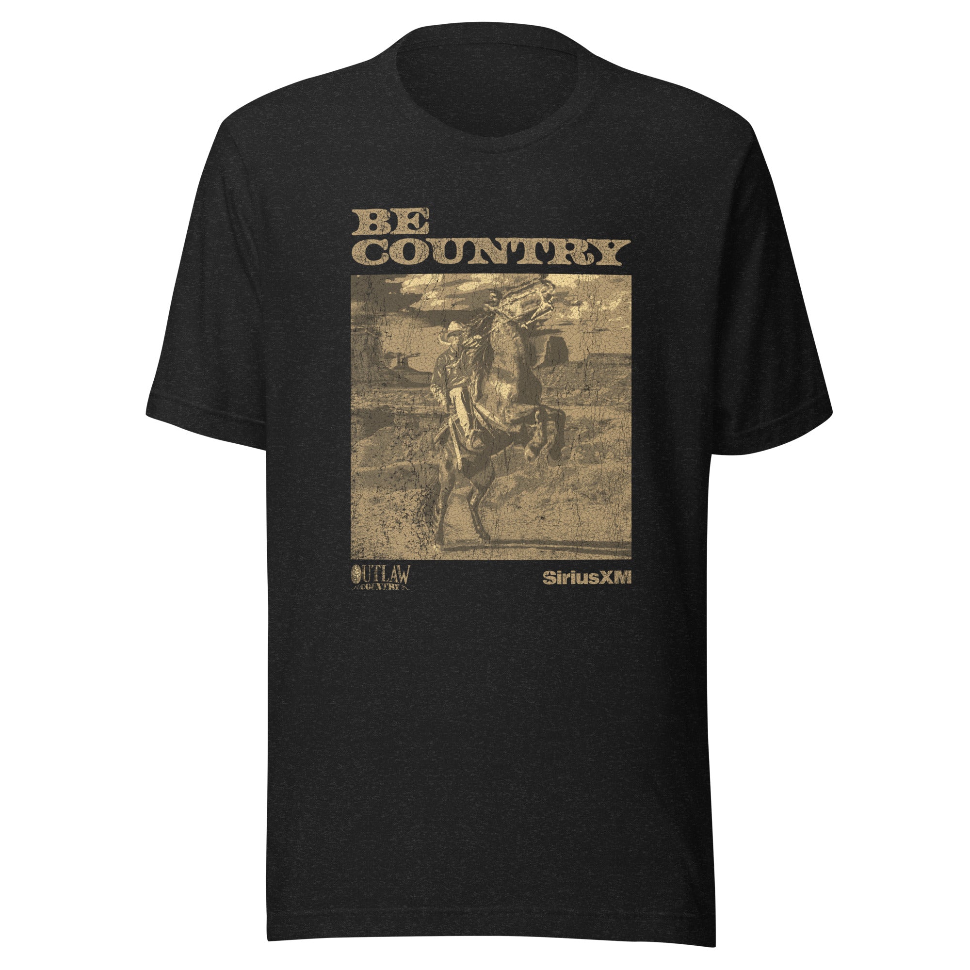 Product-only image of the black heather t-shirt laid flat, showing the full sepia graphic with 'BE COUNTRY' at the top, an image of a cowboy on horseback, and the text 'OUTLAW COUNTRY' and 'SiriusXM' at the bottom.