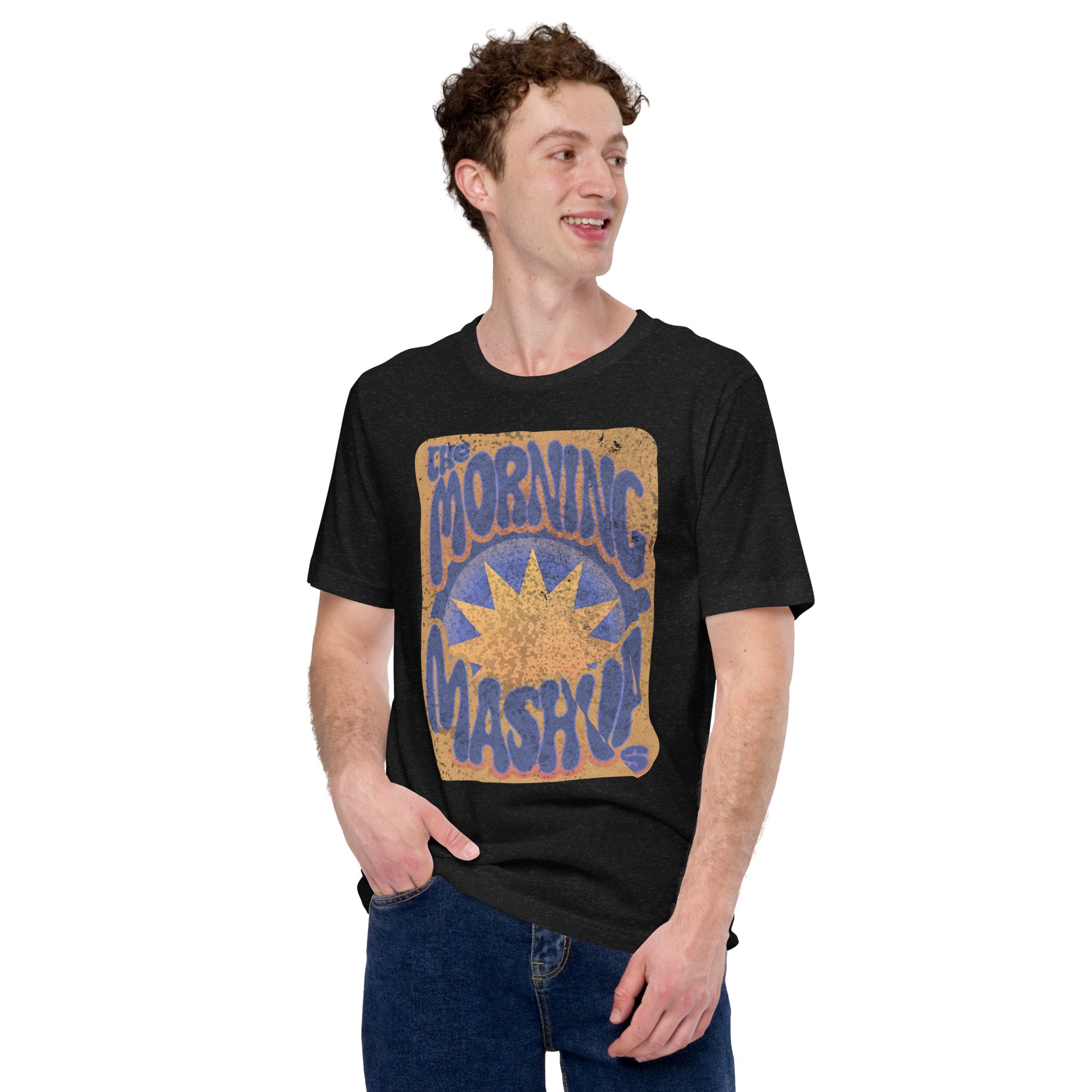A man wearing a black heather short-sleeve T-shirt with a large distressed retro graphic on the front. The design features the words 'The Morning Mash Up' in wavy blue letters surrounding an orange sunburst on a brown background. The SiriusXM 'S-Star' logo appears in the bottom right corner of the graphic.