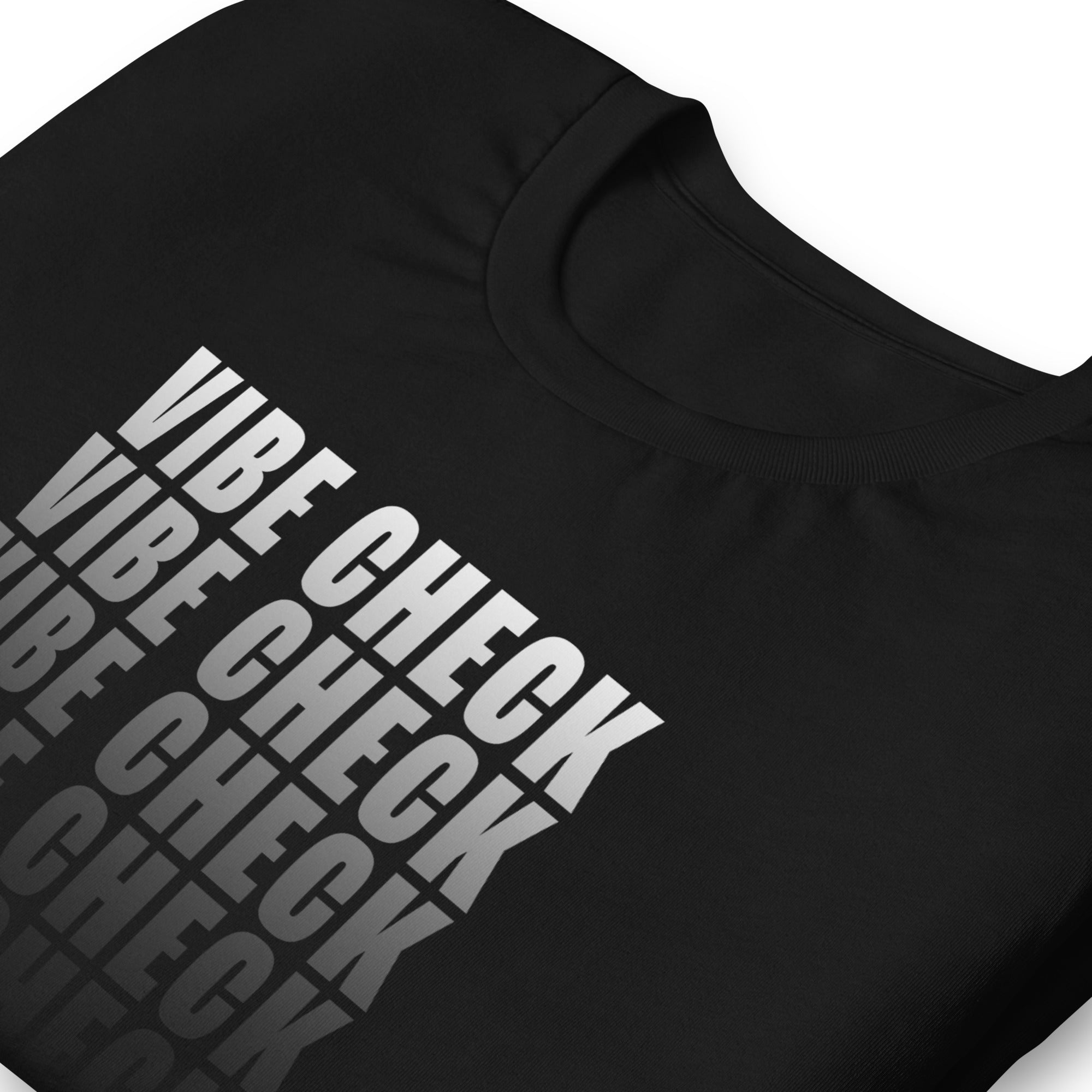 This image provides a close-up view of the design on a black t-shirt. It highlights the 'VIBE CHECK' text, which is displayed in bold, blocky capital letters with a gradient effect.