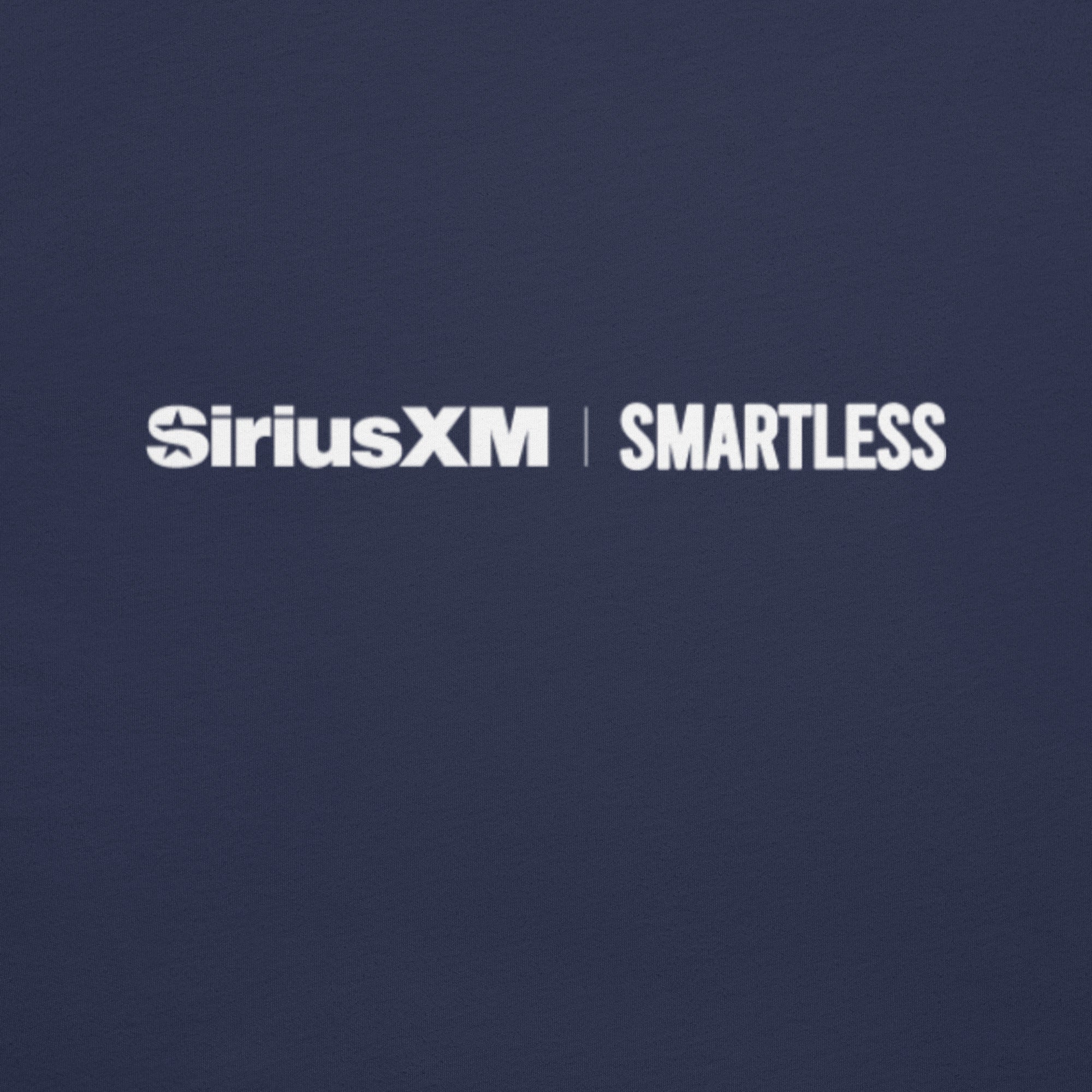 A close-up of the back of a navy blue shirt, showing the 'SiriusXM' and 'SMARTLESS' logos printed in white just below the collar.