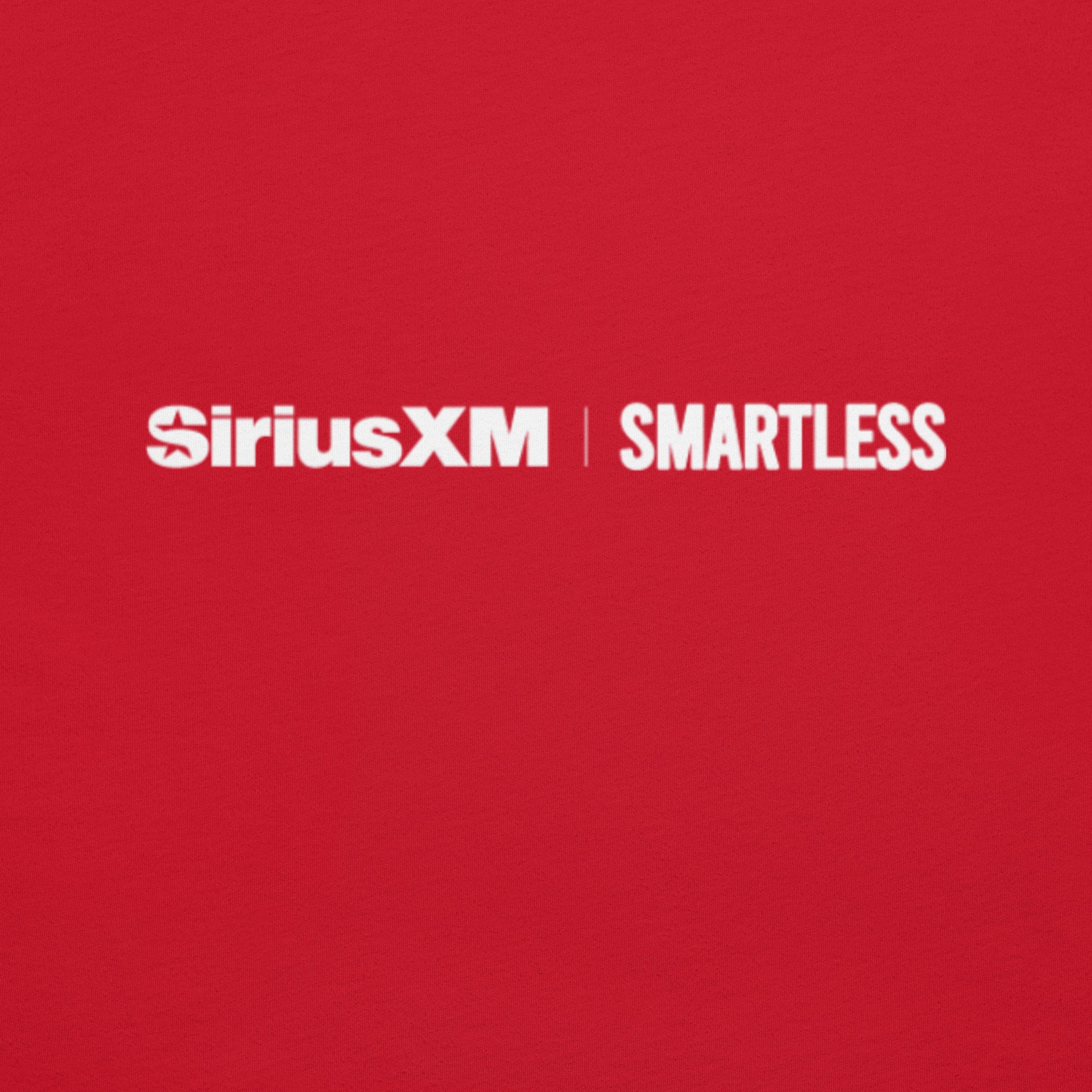 A close-up shot of the back of a red shirt showing the 'SiriusXM' and 'SMARTLESS' logos printed in white near the collar.