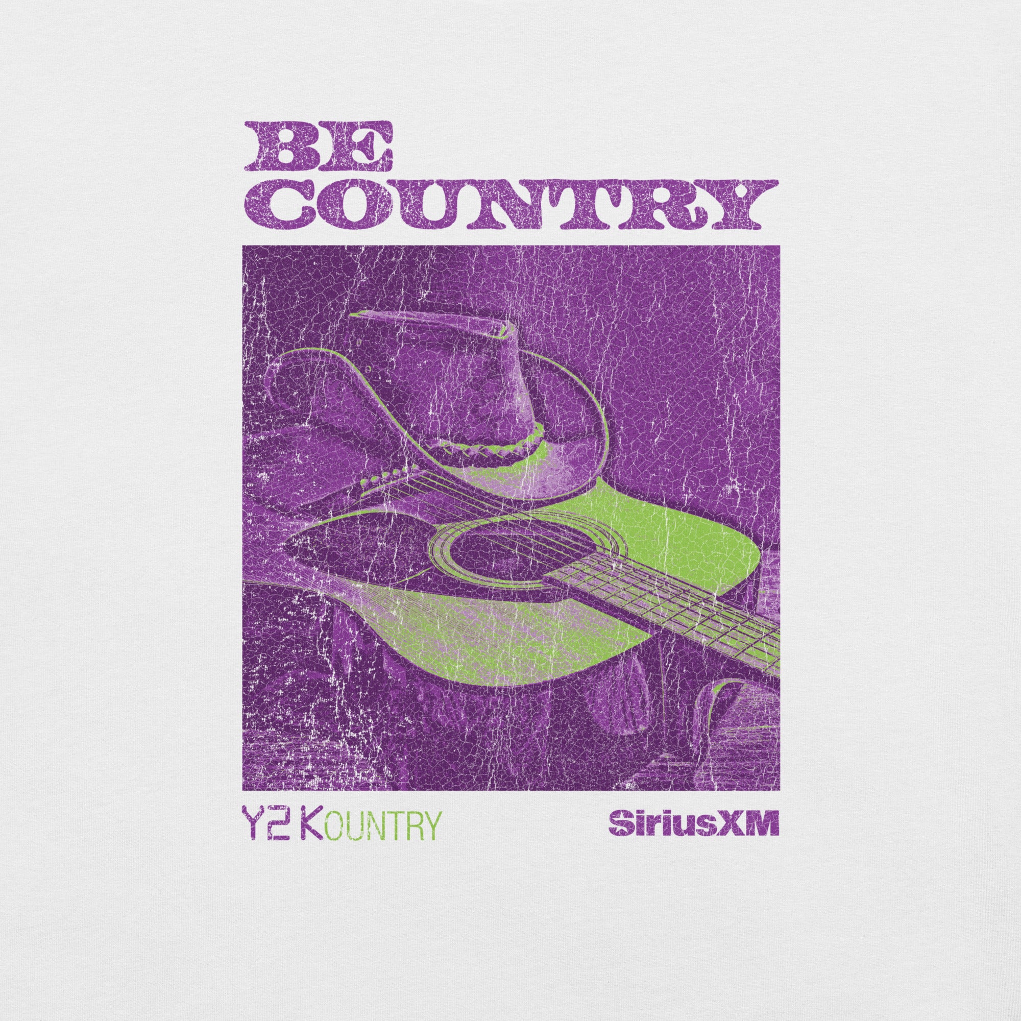 Zoomed-in view of the shirt's design featuring a green guitar and cowboy hat on a purple textured background. Text reads: 'BE COUNTRY', 'Y2KOUNTRY', and 'SiriusXM'.