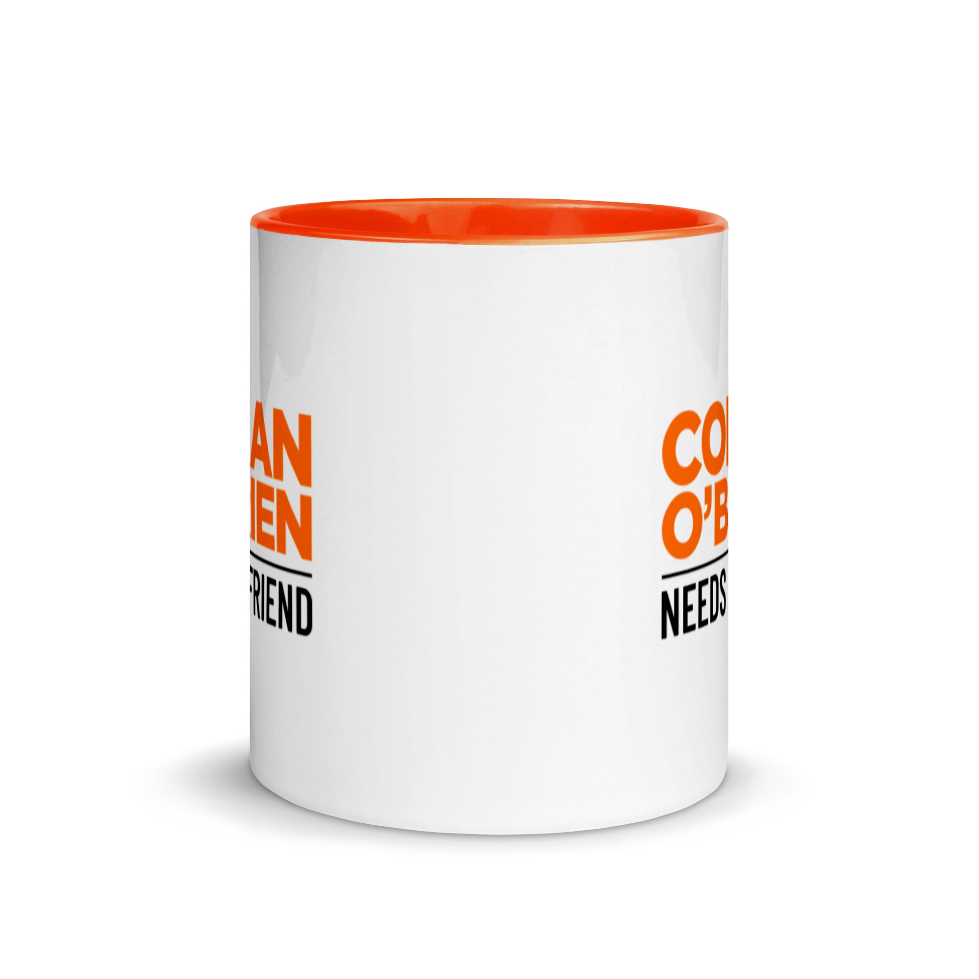 Side view of white mug with orange interior, partially featuring 'CONAN O'BRIEN NEEDS A FRIEND' logo on front and back.