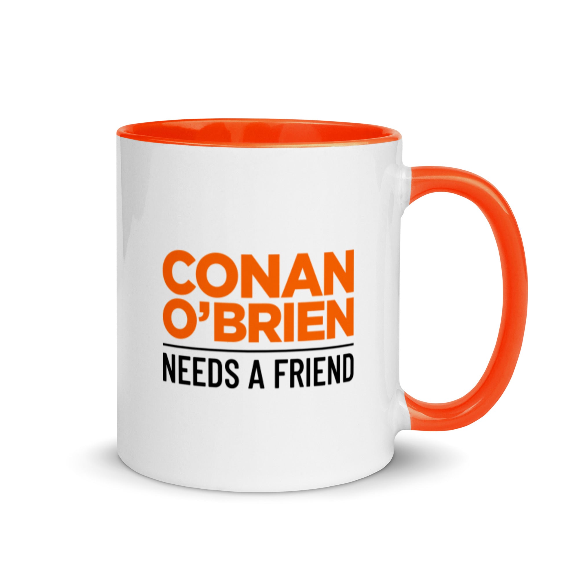 White mug with orange interior and handle on the right side, featuring black and orange 'CONAN O'BRIEN NEEDS A FRIEND' logo.