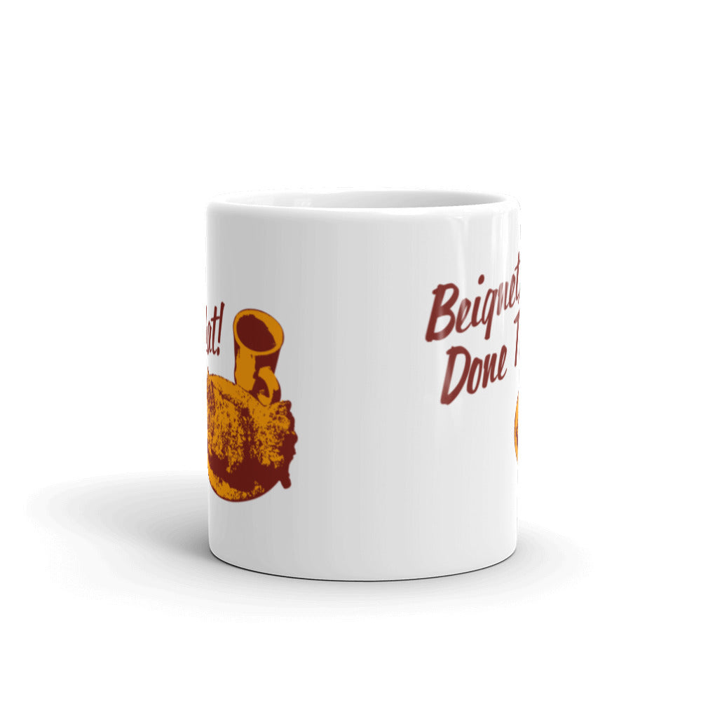 Side view of white mug partially featuring front and back text and illustrations.