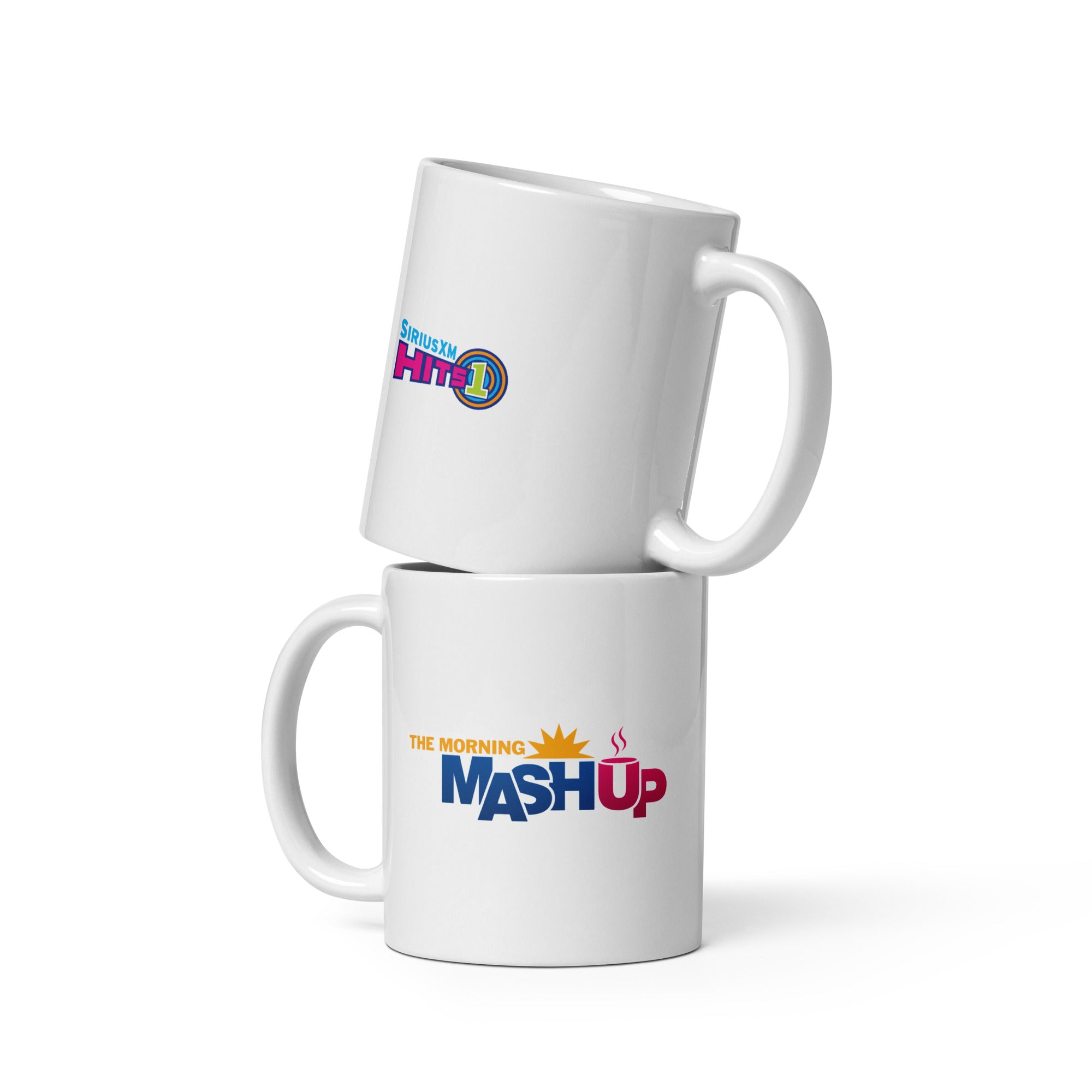 Two white coffee mugs stacked, one with 'SIRIUSXM HITS 1' logo on one side and the other featuring 'THE MORNING MASHUP' logo on the other.