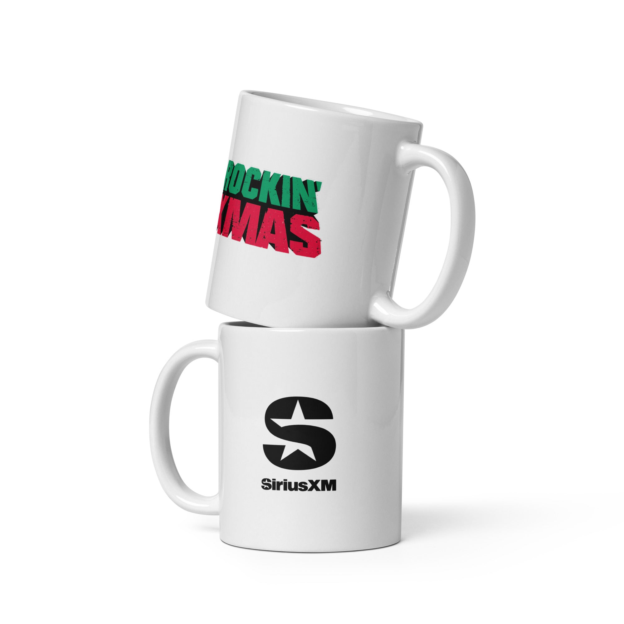 Two stacked white ceramic mugs — the top mug features red and green distressed text reading ‘ROCKIN’ XMAS,’ while the bottom mug shows the black ‘SiriusXM’ logo with a stylized star inside the letter ‘S.’
