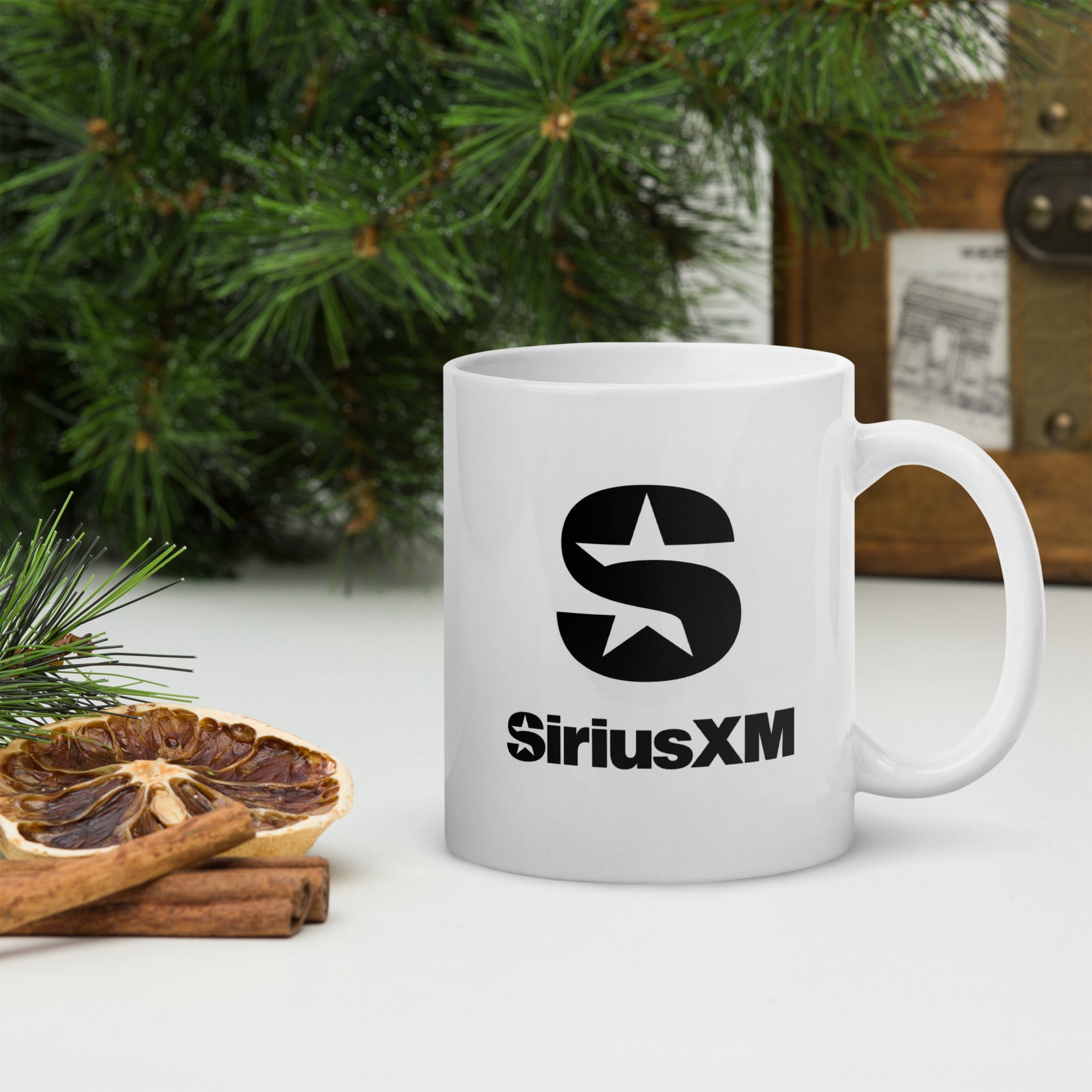 White mug with the SiriusXM star logo and the SiriusXM text logo below.