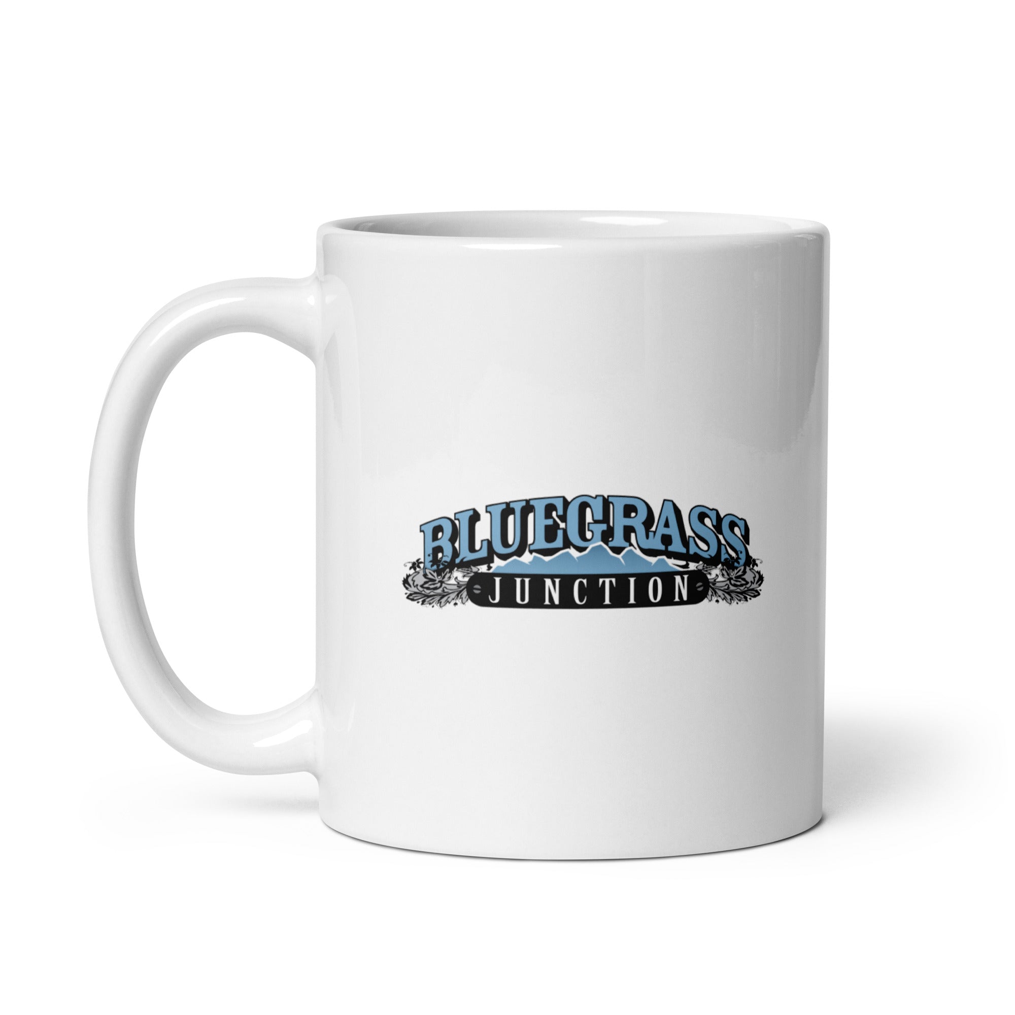 White mug featuring the text 'Bluegrass Junction' with decorative elements and mountain graphics.