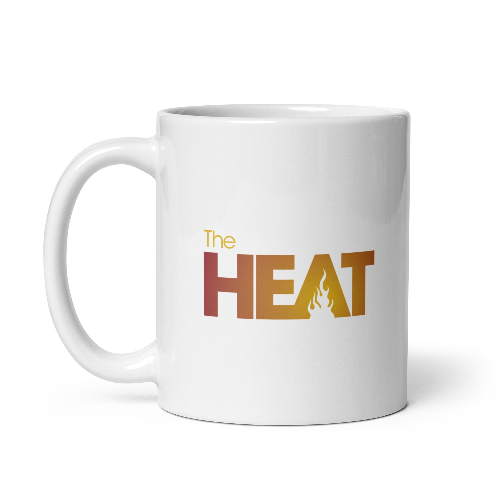 White mug featuring the text 'The HEAT' in bold yellow and reddish gradient colors, with a flame graphic in the letter 'A'.