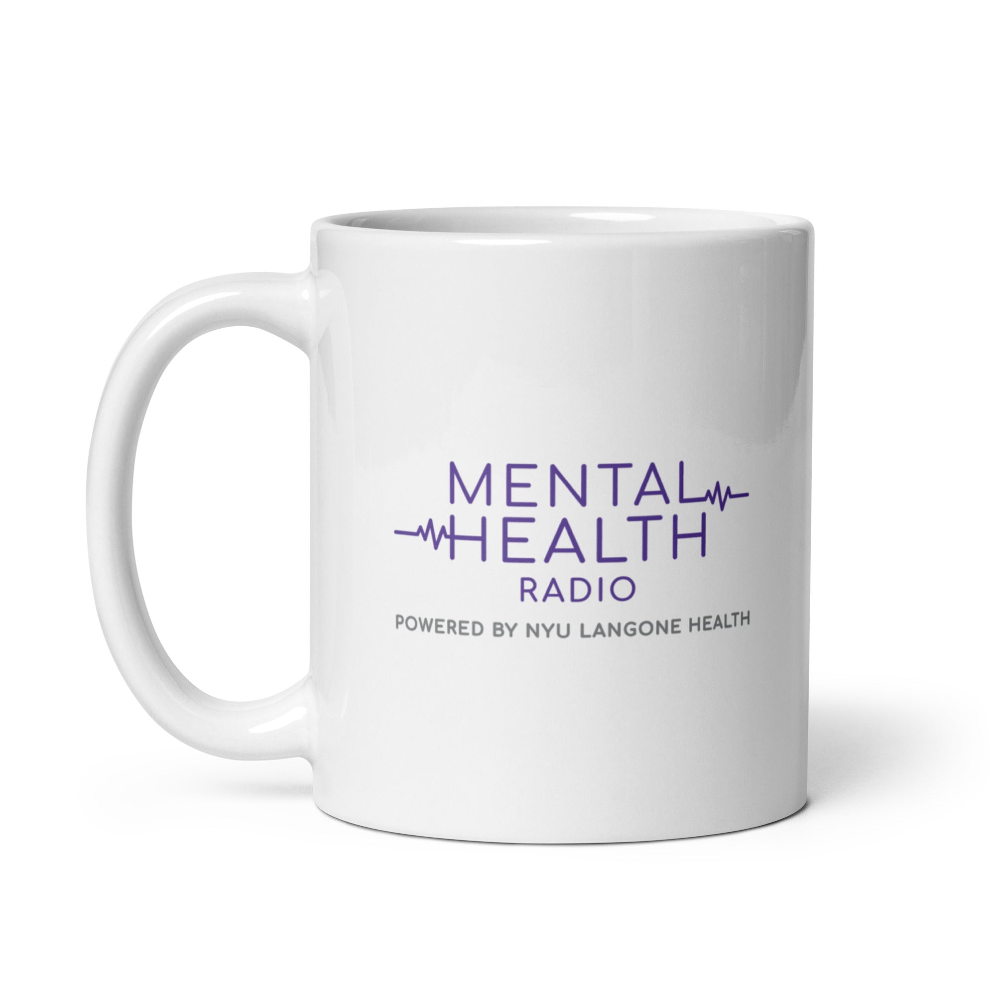 White mug with 'MENTAL HEALTH RADIO' and 'POWERED BY NYU LANGONE HEALTH' printed in purple and gray text.
