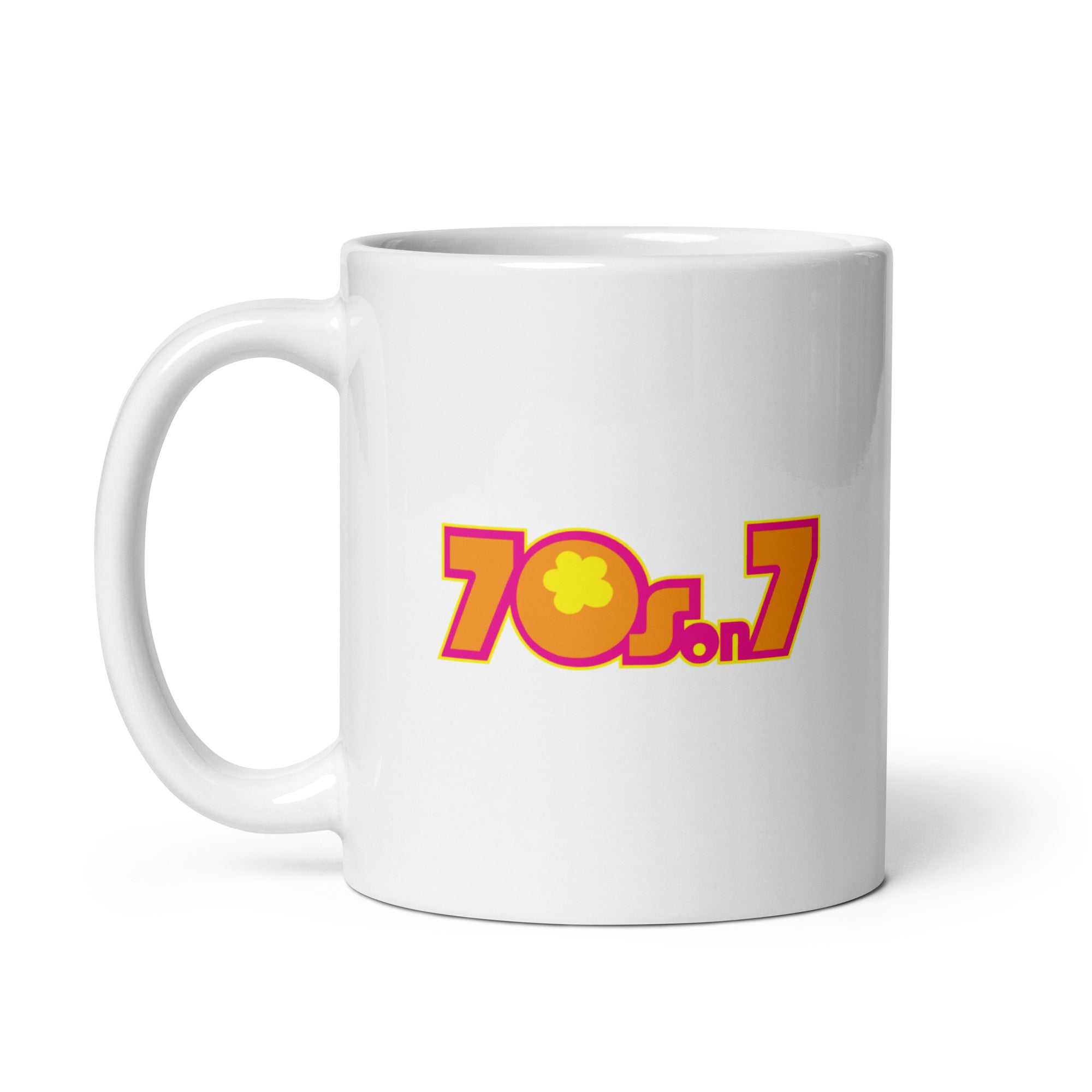 White mug featuring a colorful '70s on 7' logo in pink, yellow and orange with a flower design.