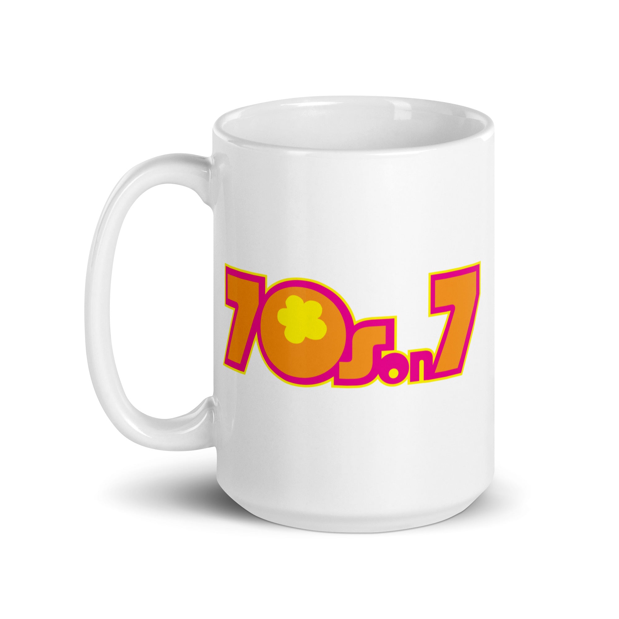 White mug featuring vibrant 70s-inspired text design '70s on 7' in pink, orange and yellow with a flower graphic.