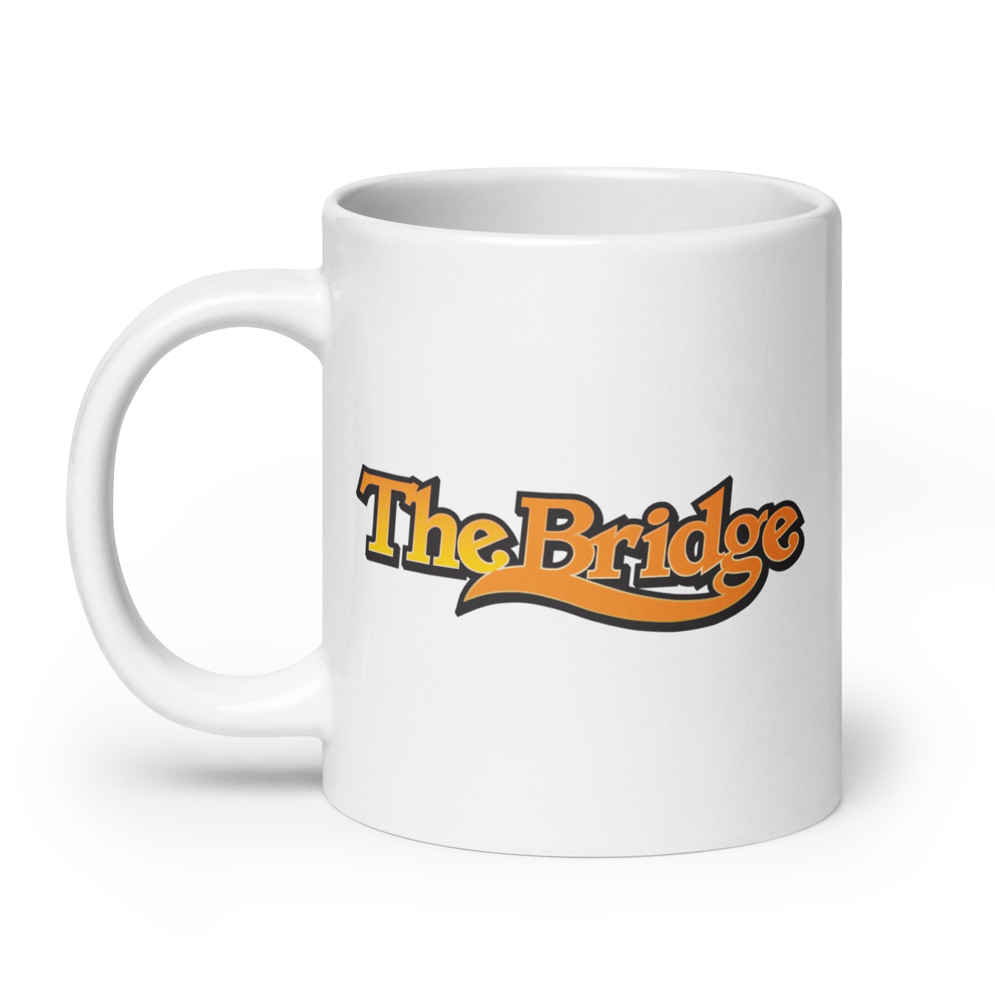 White mug with 'The Bridge' written in stylized orange and black lettering.