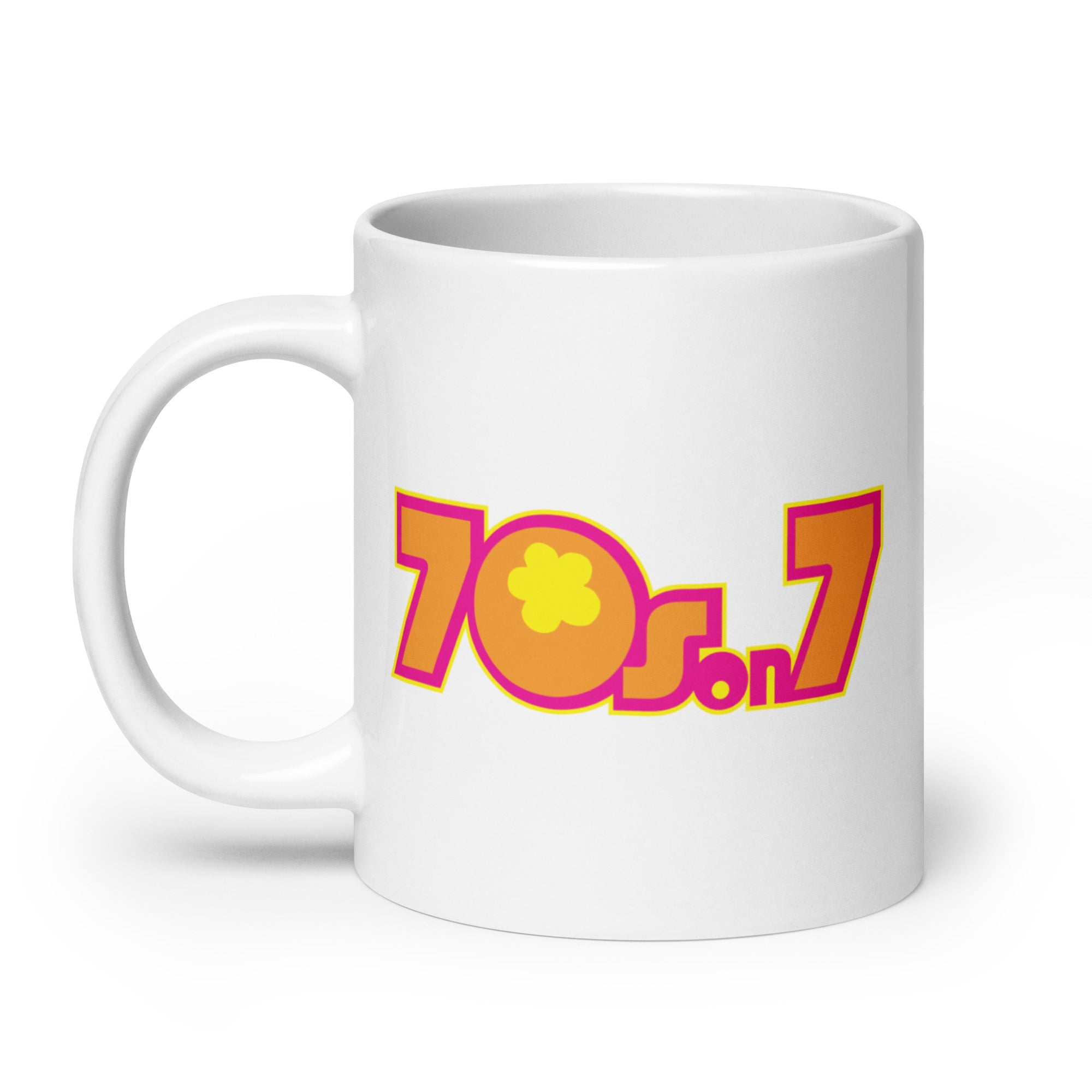 White mug featuring colorful '70s on 7' logo in pink, yellow and orange and a flower design.