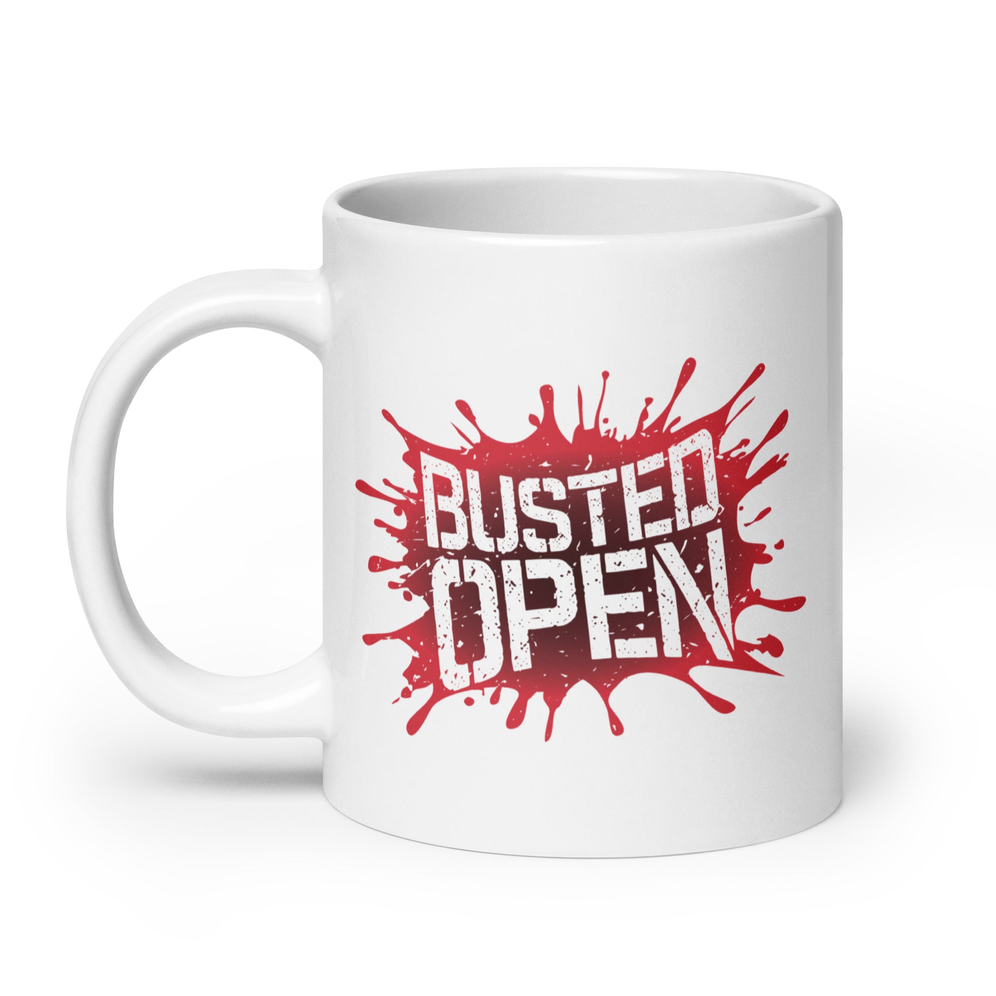 A white mug featuring the bold text 'BUSTED OPEN' with a red splatter design behind it.