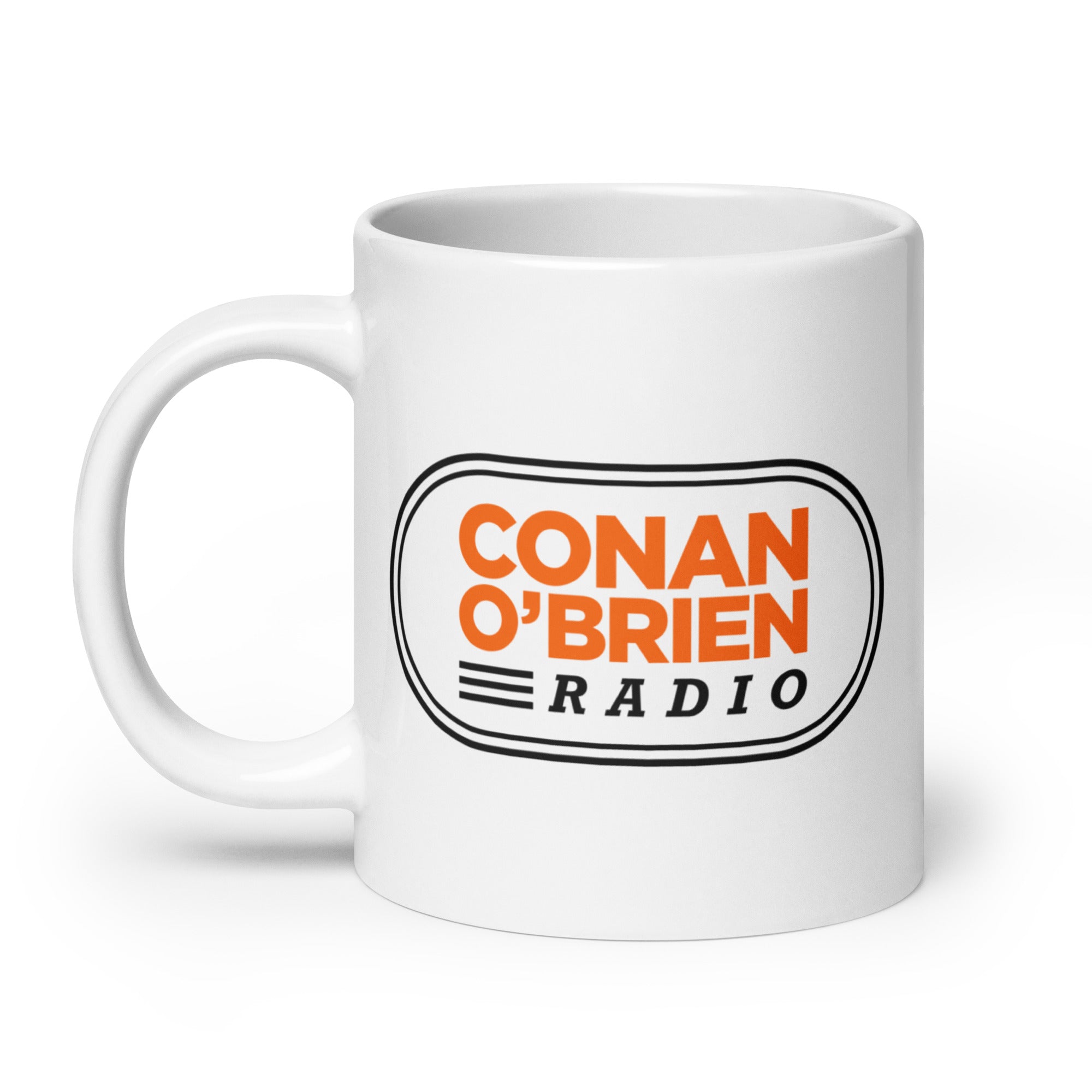 White mug featuring the text 'CONAN O'BRIEN RADIO' in orange and black design.