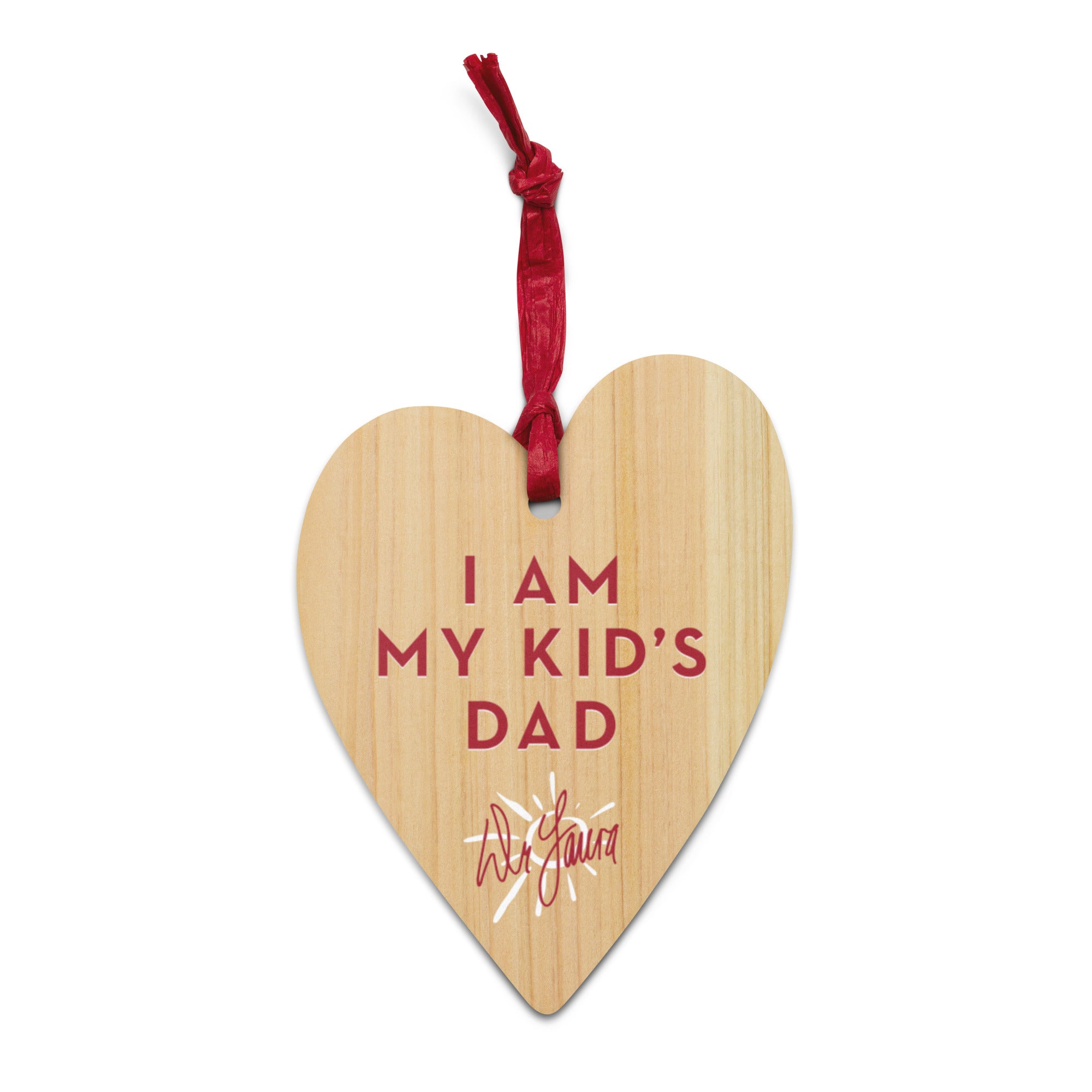Wooden heart-shaped tag with the phrase 'I AM MY KID'S DAD' and a 'Dr. Laura' signature at the bottom, tied with a red ribbon.